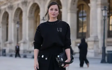 Czarny sweter oversize z ozdobnymi ćwiekami i spódniczka z kieszeniami. Stylowe sweter oversize stylizacje na co dzień.