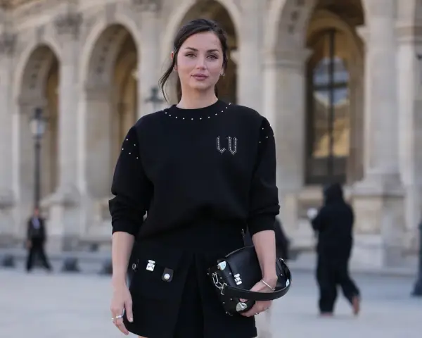 Czarny sweter oversize z ozdobnymi ćwiekami i spódniczka z kieszeniami. Stylowe sweter oversize stylizacje na co dzień.